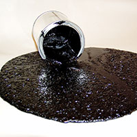 Bitumen being poured out of a tin