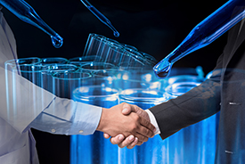 Scientist and businessman shaking hands