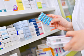 pharmacist holding medicines