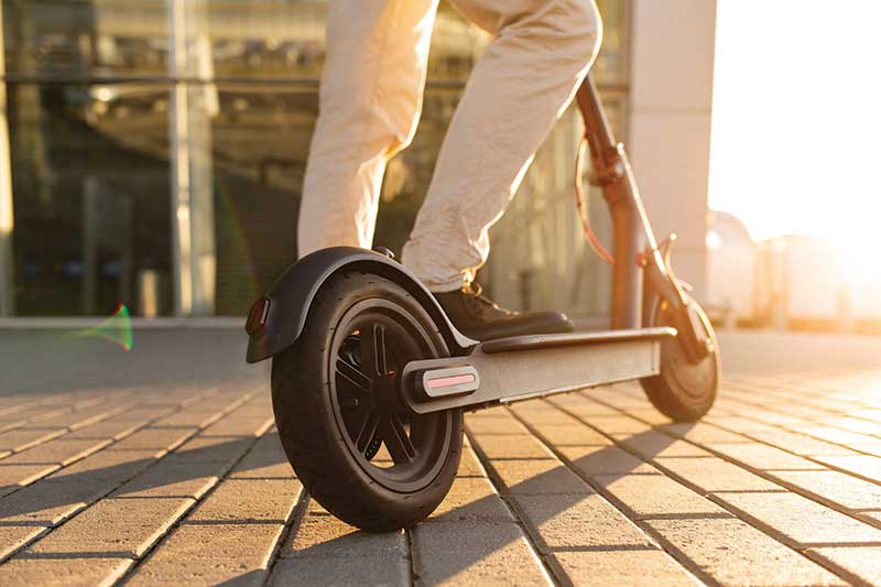 Man mounting electric scooter