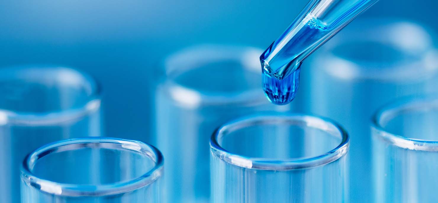 pipette dropping sample into testtube research science
