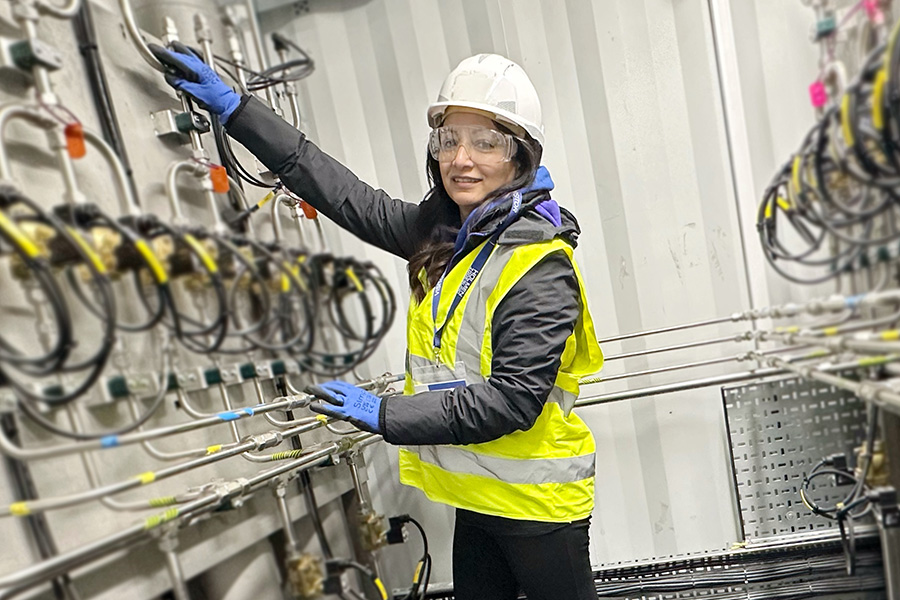 Beena Sharma of CCUI with the carbon capture equipment for Flue2Chem. Credit: Flue2Chem