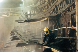 A technician services the spraying system on the Mary Rose.