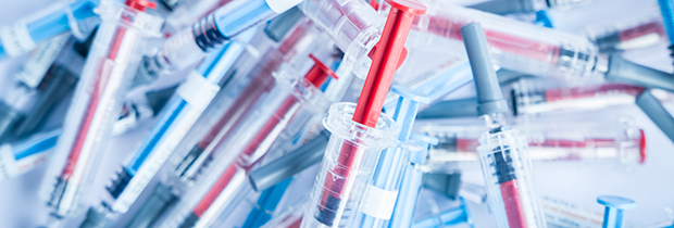 Medical waste pile of syringes