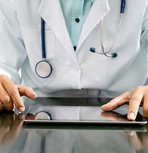 /-/media/images/news/2021/1/maledoctorsittingatdeskwithtabletlanding.ashx?h=300&w=290&hash=6653FA1728CC2D914FE053354845D2F2