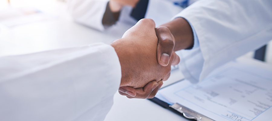 SCIWeek - 20 December 2022 - image of handshake between two people in lab coats