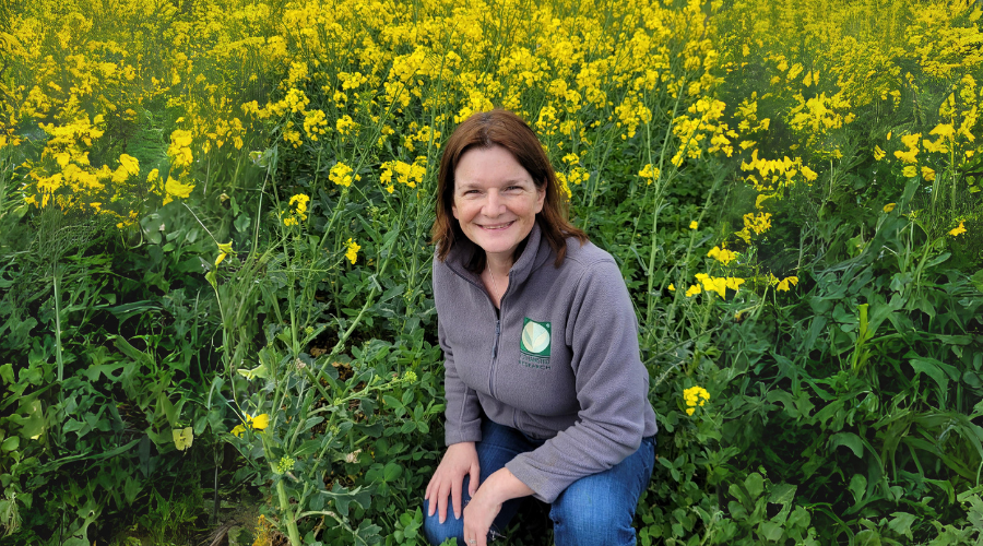 Dr Sam Cook in front of Oilseed Crops