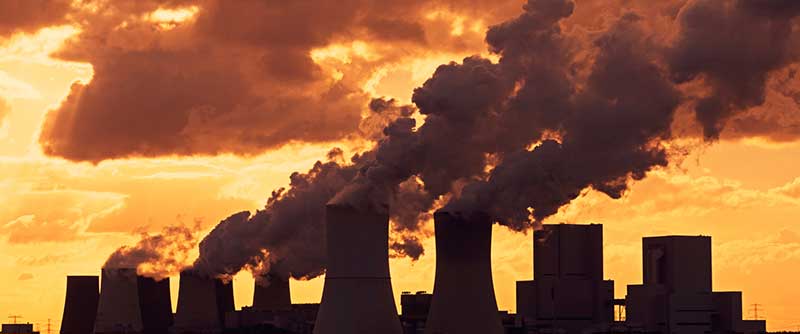 Industrial chimneys with smoke sunset