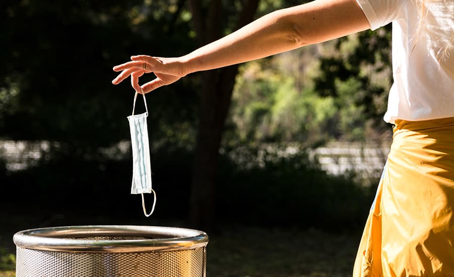 SCIblog - 7th May 2021 - No masking the pollution problem - image of woman disposing of mask in bin