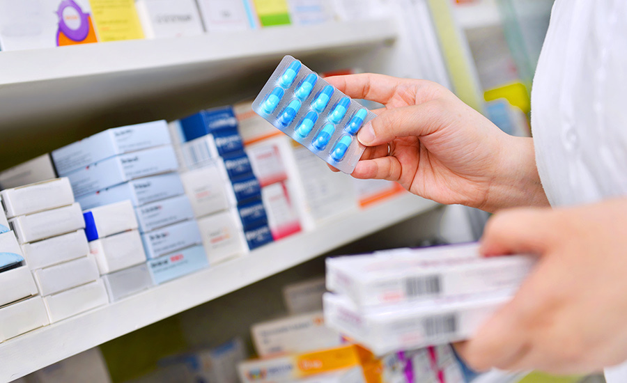 SCIblog - 2 September 2021 - Taking action on AMR - image of pharmacist holding pills and pill packs