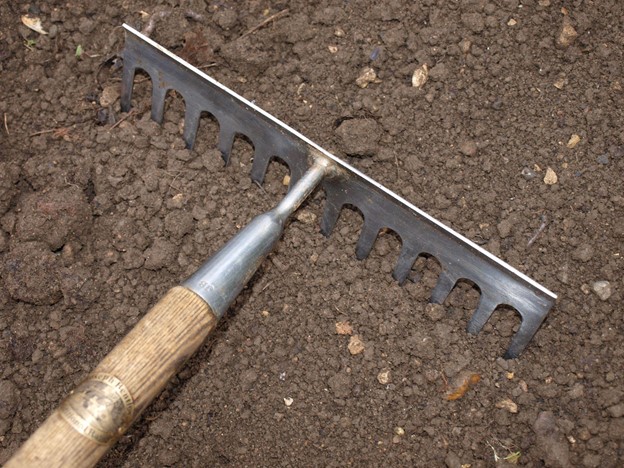 SCIblog - Professor Geoff Dixon - Soil Cultivation - image of Raking down soil producing a fine tilth