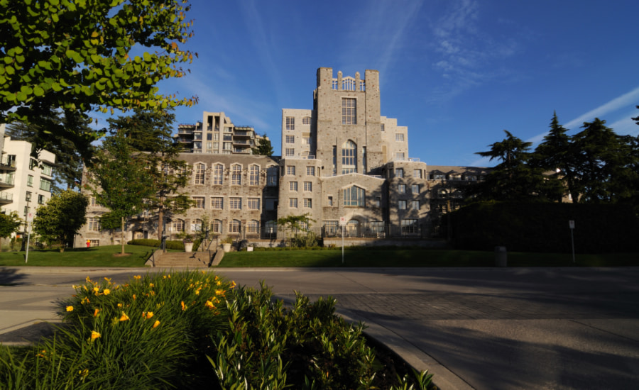 SCIBlog - 31 October 2022 - image of building at University of British Columbia with blue sky and daffodils