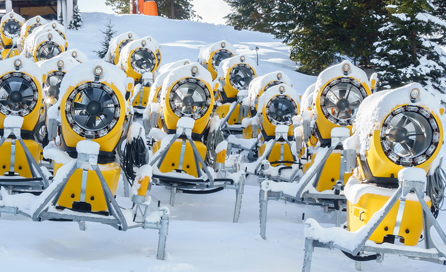SCIblog - 08 February 2022 - Artificial Snow - image of a number of yellow snow cannons / snow making machines