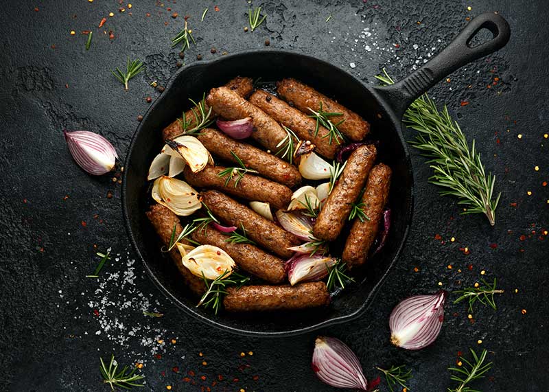 Vegan sausages in pan
